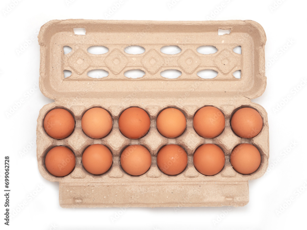 Top view of brown eggs in egg carton on white isolated background.