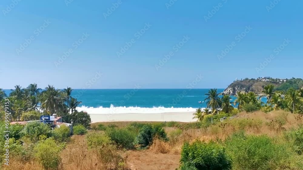 Sun beach sand surfer waves palms in Puerto Escondido Mexico.