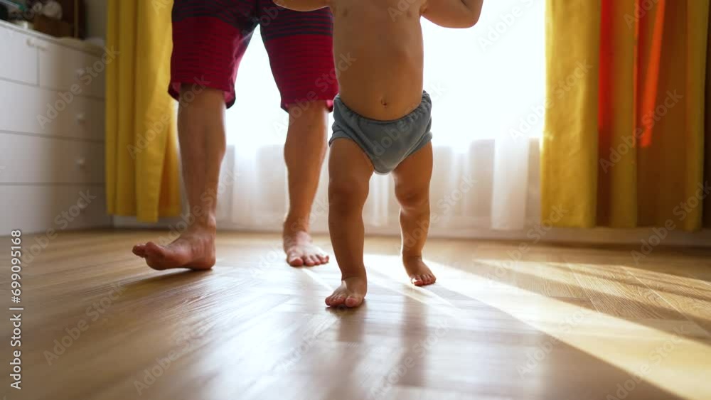 Close-up portrait of baby. happy child learns to walk in kindergarten. child development and learning. baby's bare feet close-up. The nanny helps child learn to walk. baby's dream.happy family concept
