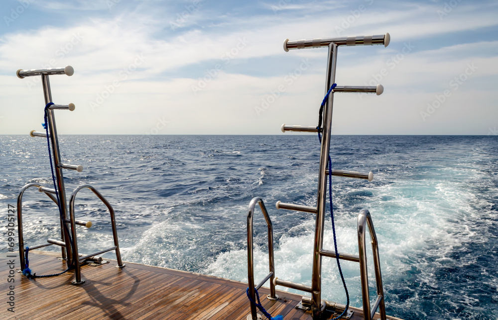 feed boats with raised ladders against the blue water of the Red Sea feed boats with raised ladders against the blue water of the Red Sea