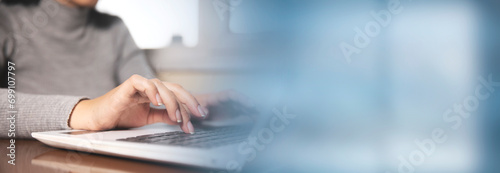 Business woman hands typing on laptop computer keyboard photo