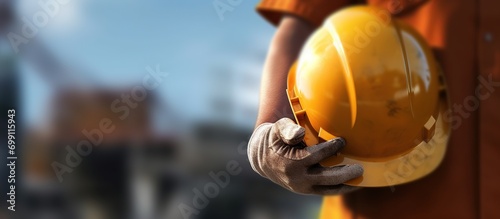 construction worker holding protective helmet