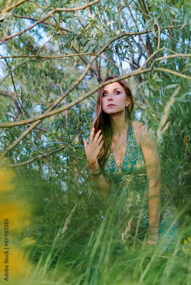 Outdoor portrait of young beautiful woman with long hair against green nature Outdoor portrait of young beautiful woman with long hair against green nature