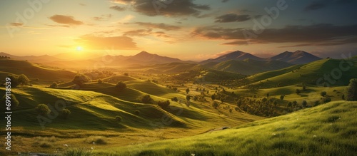On green hill with beautiful sunset view in summer mountain landscape
