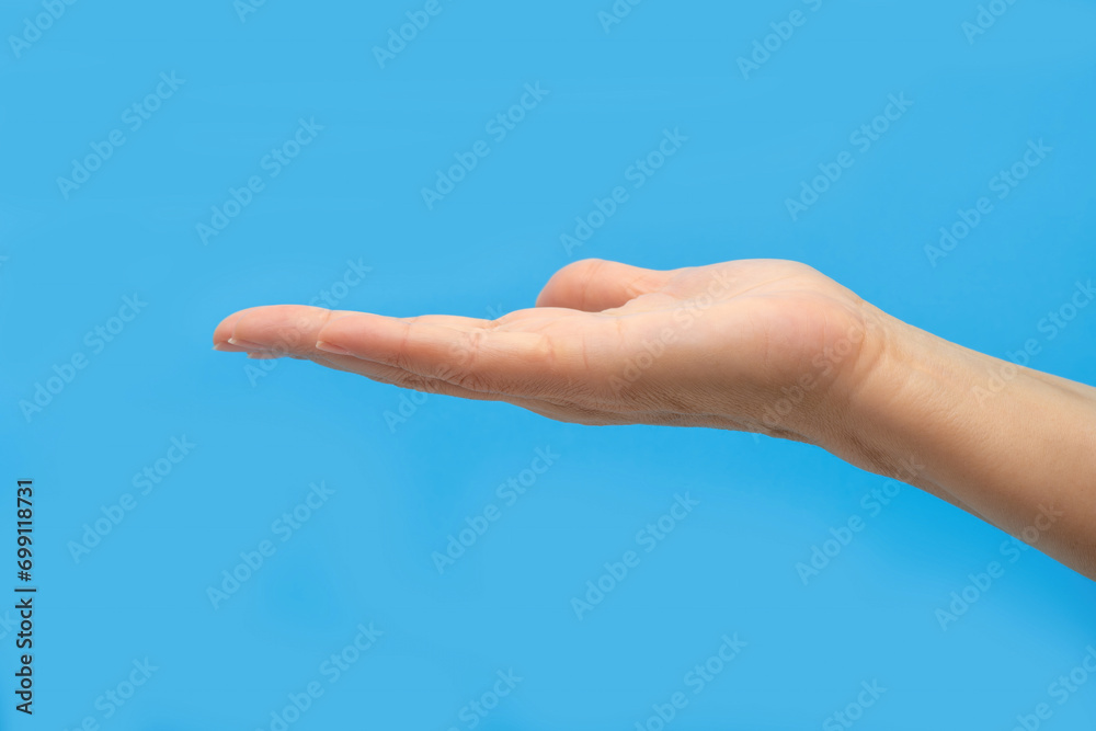 Female hand on a blue background. The concept of a healthy lifestyle.