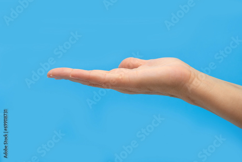 Female hand on a blue background. The concept of a healthy lifestyle. © Valeryi