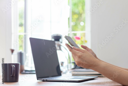 Young woman is shopping online through mobile application by paying with her credit card Convenience of paying through shopping online. Concept of online shopping and spending through credit card. © thatinchan