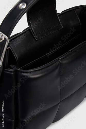 Open women's Black Leather Bag inside with pockets and several compartments, interior departments. Open Handbag Crossbody isolated on White Background. Close up. Banner, advertisment