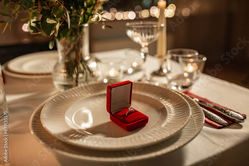 engagement ring in red box on served table photo