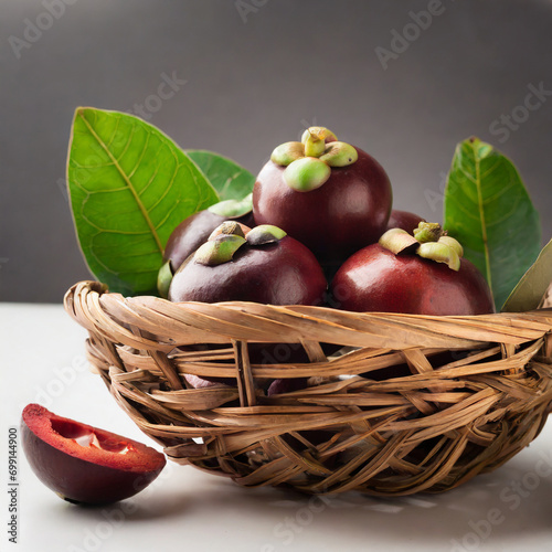 fresh kokum or garcinia indica fruit from india isolated over white or in cane basket with leaves. selective focus