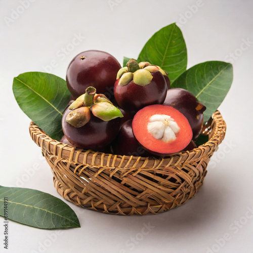 fresh kokum or garcinia indica fruit from india isolated over white or in cane basket with leaves. selective focus photo