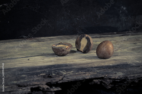 still life with avocado seeds, small roses and other gift of mother nature