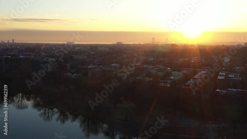 Slow aerial dolly in towards western Brooklyn over Prospect Park at golden hour (ID: 699162319)