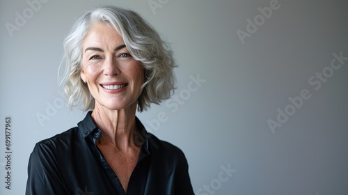 Smiling beautiful mature business woman on white background. Older senior business woman, 60s lady professional female ceo, coach looking at camera 