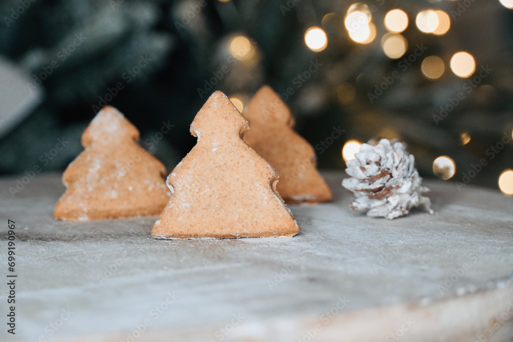 Close-up of Christmas tree biscuits on wooden table with out of focus lights in the background. Close-up of Christmas tree biscuits on wooden table with out of focus lights in the background.