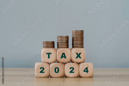 Word tax with number 2024. Tax icon in the wooden cube for income tax return and submit tax for payment tax documents online to the government.