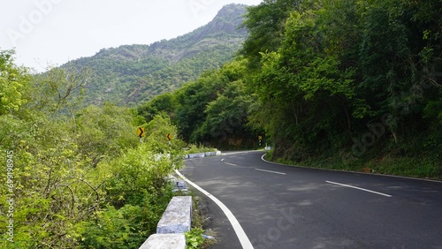 Beautiful scenic road to kodaikanal hills surrounded by lush green Trees photo