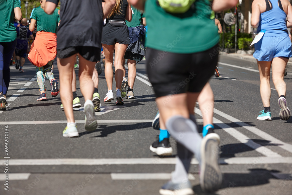 Runners on the street. Healthy lifestyle. Jogging exercise. Athletics Runners on the street. Healthy lifestyle. Jogging exercise. Athletics