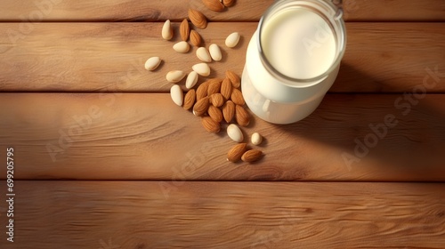 Almond milk in a glass bottle and nuts on a wooden background