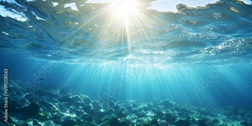 Sun rays beneath sea with bubbles ascending to water top in Mediterranean France. photo