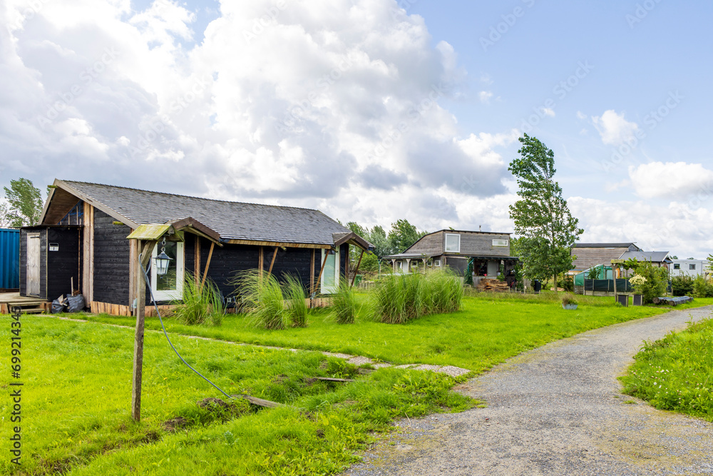Ten Boer, The Netherlands - August 8, 2023: Tiny house area Woldwijk in Ten Boer municipality Midden-Groningen in Groningen province in The Netherlands Ten Boer, The Netherlands - August 8, 2023: Tiny house area Woldwijk in Ten Boer municipality Midden-Groningen in Groningen province in The Netherlands