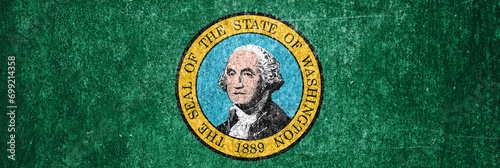 Banner of the Washington State grunge flag. Dirty Washington State flag on a metal surface. © andyborodaty