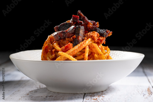 real italian Amatriciana is a typical first course of Lazio region in Italy whit tomato, bacon, chili what you eat in Rome photo