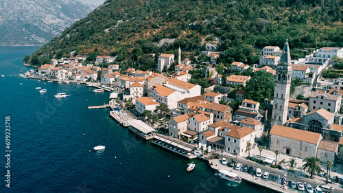 Cars are parked on the promenade near the Church of St. Nicholas. Perast  Montenegro. Drone
