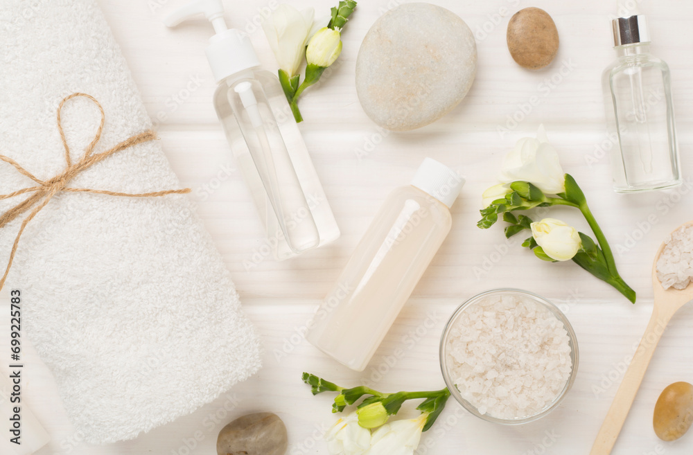 Flat lay with spa products and flowers on wooden background Flat lay with spa products and flowers on wooden background