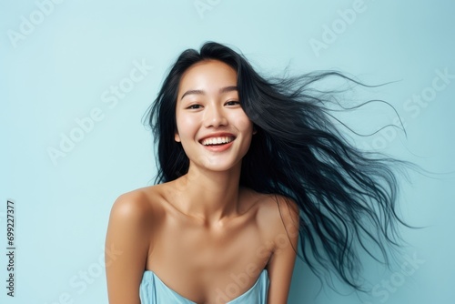 A woman with long black hair smiling