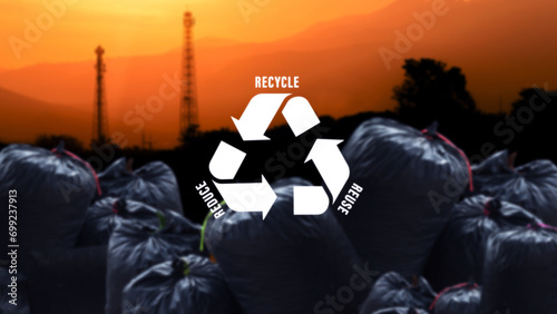 Reduce, reuse, recycle symbol on black garbage bags of rubbish on industry background, ecological metaphor for ecological waste management and sustainable and economical lifestyle.