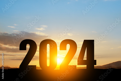 Silhouette 2024 with sunset sky at mountain and number like 2024 abstract background. Concept of start with strategy, win, plan, goal and objective target. photo