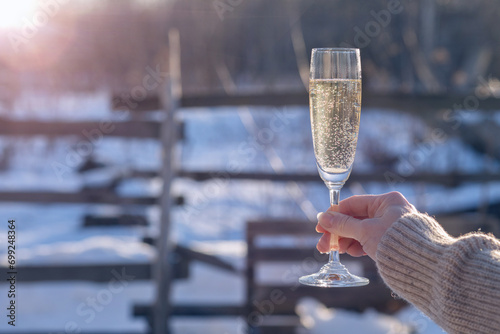 A raised glass of champagne for Christmas and New Year.