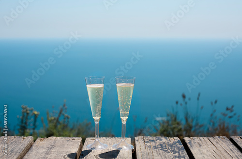 Champagne glasses by the blue sea photo