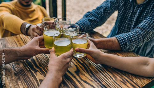 Friends having a great time in bar. Group of young people chatting and having a drink at the bar