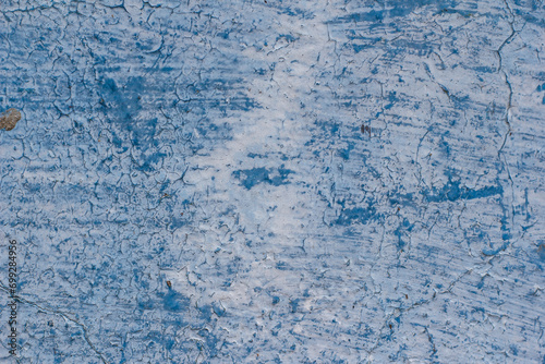 Shabby blue wall with cracks