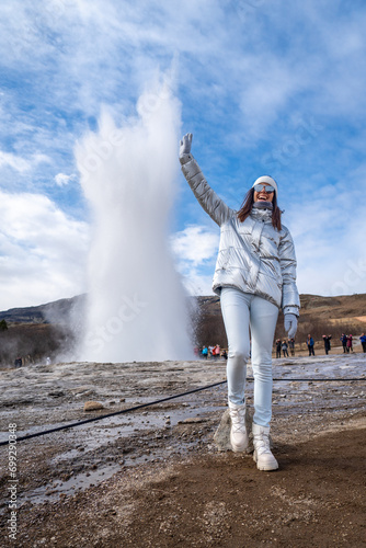 Woman posing with metallic jacket in Geysir, Iceland photo