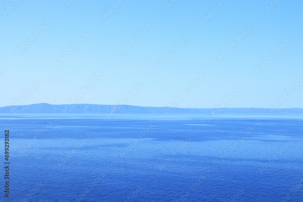 Beautiful view of the sea and mountains. Blue turquoise sea water background. Blue ocean background. Beautiful crystal clear sea water in Croatia. Vacation and summer concept. Landscape Beautiful view of the sea and mountains. Blue turquoise sea water background. Blue ocean background. Beautiful crystal clear sea water in Croatia. Vacation and summer concept. Landscape