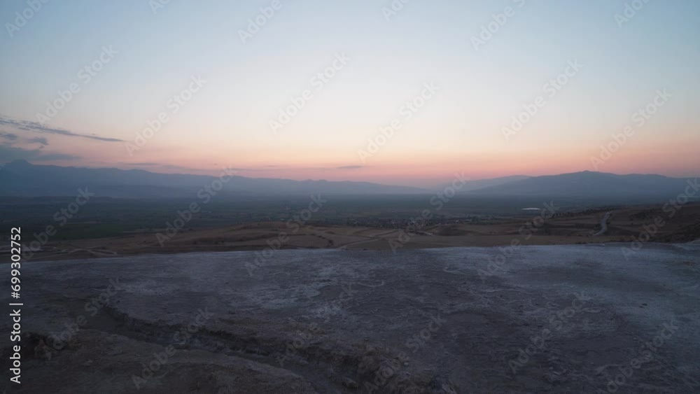 Ancient dry water channel made of travertine against the background of the evening valley in pamukkale in turkey Ancient dry water channel made of travertine against the background of the evening valley in pamukkale in turkey