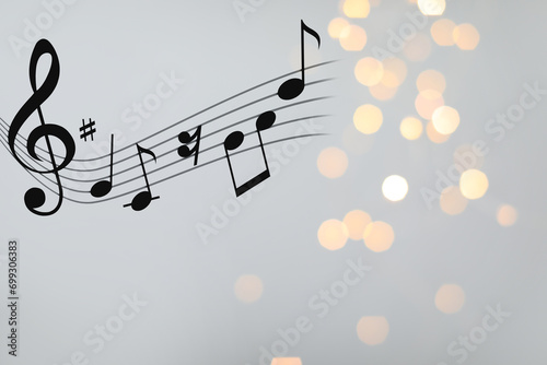 Music notes on blurred background, bokeh effect