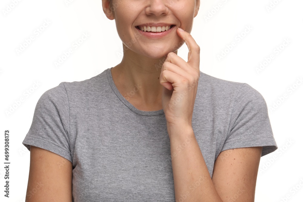 Woman showing her clean teeth and smiling on white background, closeup Woman showing her clean teeth and smiling on white background, closeup