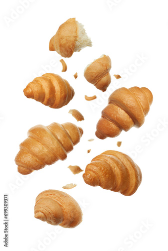 Delicious fresh croissants falling on white background