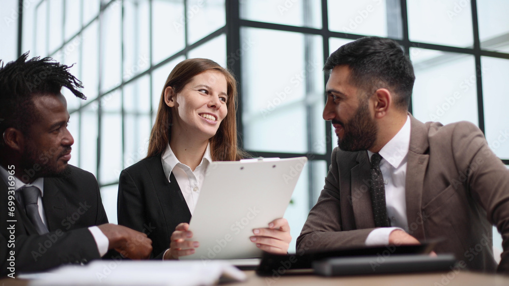 Three business people in the office working together. Three business people in the office working together.