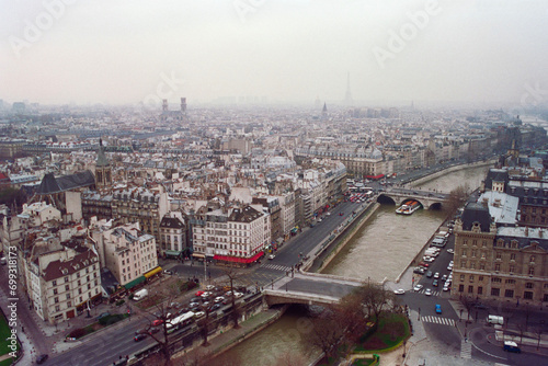 Fototapeta Naklejka Na Ścianę i Meble -  Grainy film photograph of foggy buildings and streets in historic Paris France.  Photo taken December 1990.