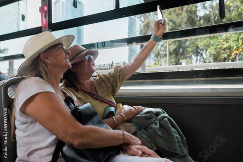 Tourists take a selfie inside the bus.