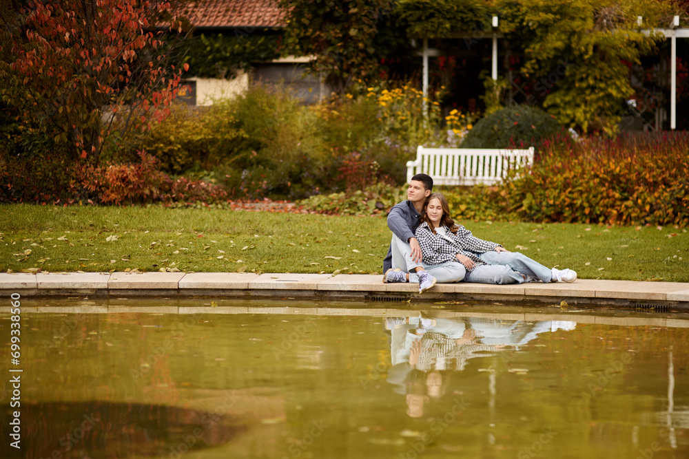 Young couple kissing and rejoices at the lake. lovely young couple kissing outdoors in autumn. Loving couple walking in nature. Autumn mood. Happy man and woman hugging and kissing in autumn. Love Young couple kissing and rejoices at the lake. lovely young couple kissing outdoors in autumn. Loving couple walking in nature. Autumn mood. Happy man and woman hugging and kissing in autumn. Love