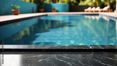 empty black marble table with blurry swimming pool background, backdrop with copy space