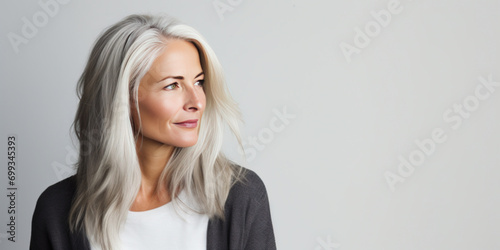 Middle aged woman with beautiful white hair, copy space photo