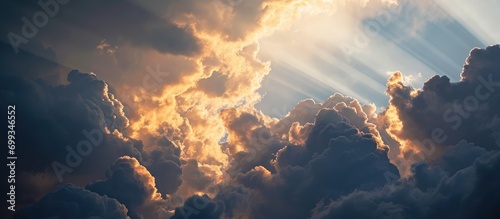 Sunlight piercing through clouds in the sky.
