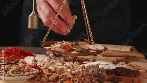 Ancient Chinese medicine and different herbal ingredients on table. photo